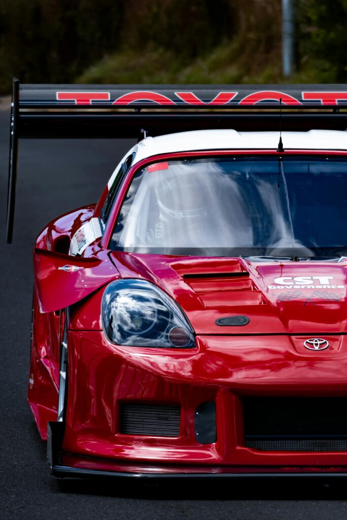 Vibrant red Toyota racecar with spoiler on a track, captured in Cape Town.